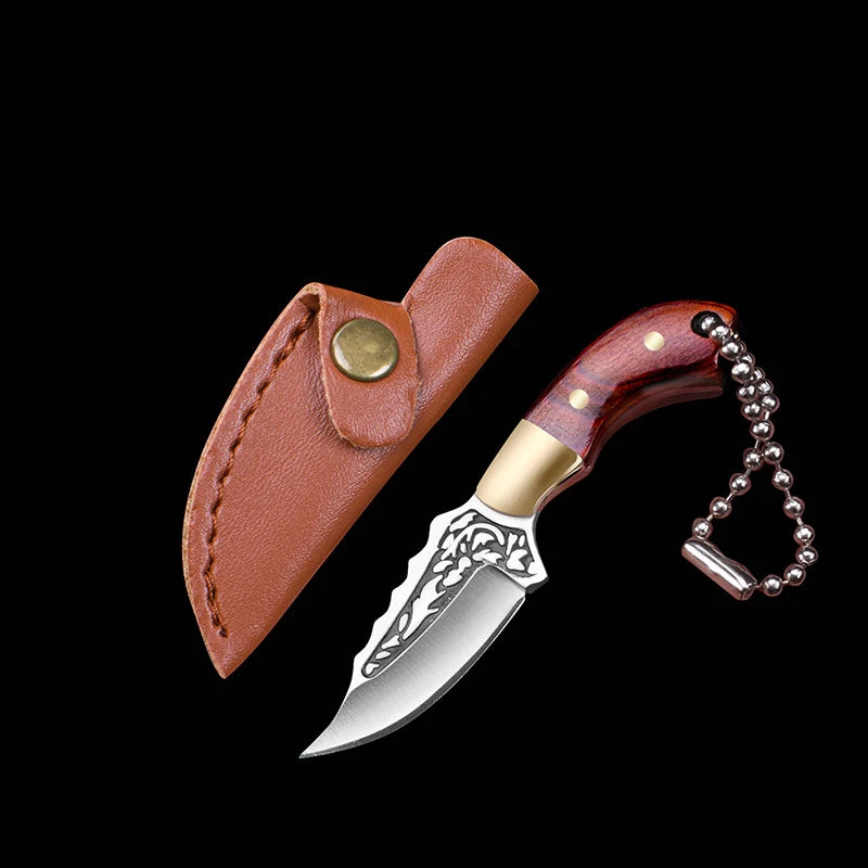 A compact fixed blade knife with a silver blade and brown leather sheath, featuring a gold-colored handle.