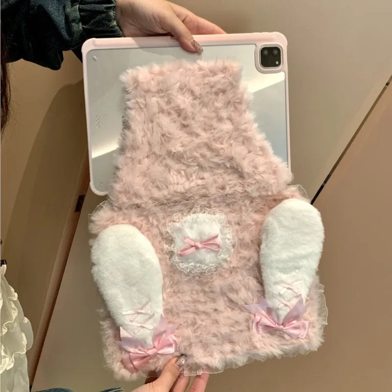 A pink fluffy rabbit plush case designed to fit an iPad, featuring white ears and a pink bow.