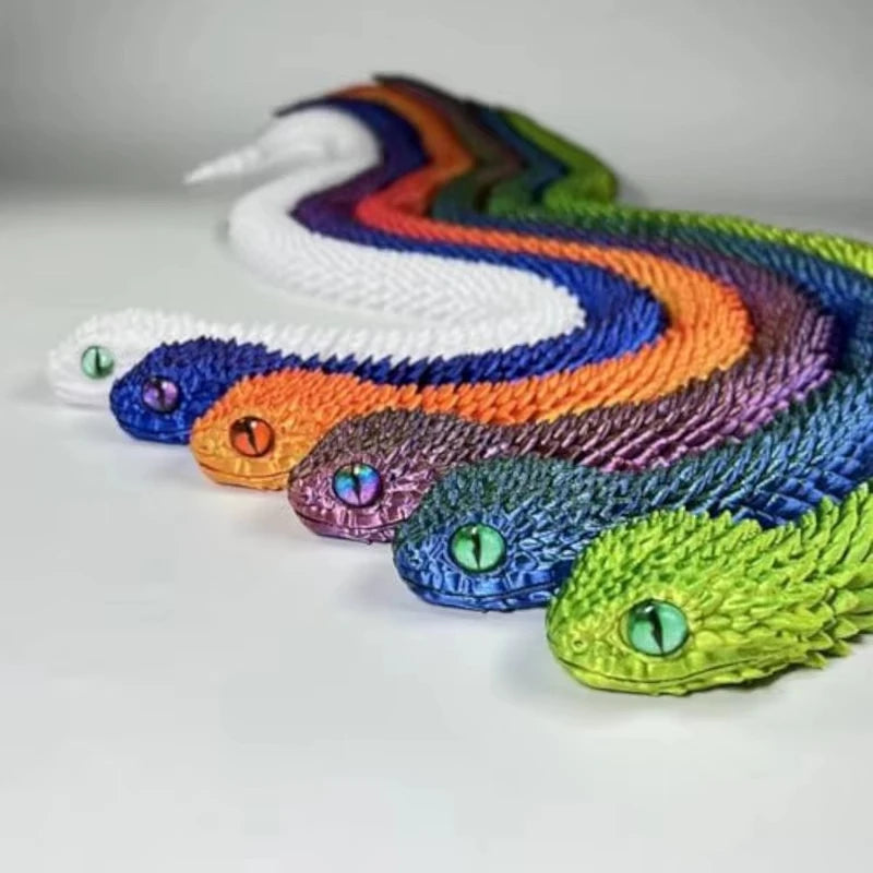 A colorful, articulated 3D printed snake figurine with iridescent scales in shades of purple, orange, and white.