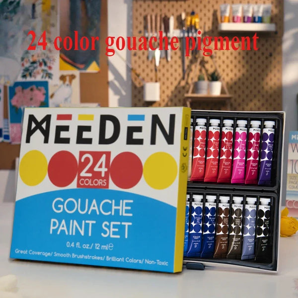 A box of a 24 color gouache paint set with tubes of paint and brushes displayed on a white surface.
