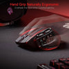 A close-up view of a black wireless MMO gaming mouse with red lighting resting on a dark surface.