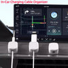 Three white magnetic cable clips are shown next to a laptop screen displaying a map and navigation interface.