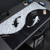 A black mouse pad featuring a white, wavy koi pattern on a dark background.