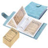 A teal fabric folder and envelope set for storing garden seeds with labeled paper inserts.