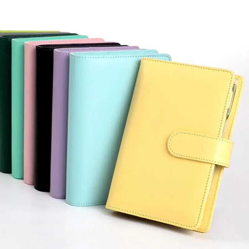 A set of colorful A6 PU leather budget binders with cash envelopes lined up.