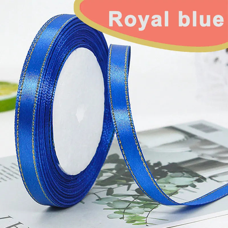 Roll of royal blue satin ribbon with a gold edge