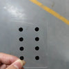 A hand is placing small black circular items onto a clear plastic sheet for DIY mouse skates.