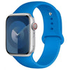 A blue silicone sport band worn around a silver Apple Watch.