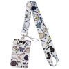 A white and black cartoon cat card holder lanyard with a patterned strap and a metal clip.