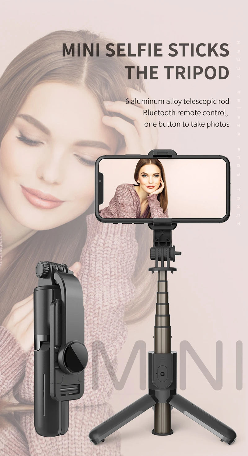 A close-up of a mini selfie stick with an LED fill light mounted on a tripod stand, shown next to a smartphone.