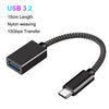 Black nylon braided USB 3.2 cable adapter connecting a USB-C connector to a USB-A plug.
