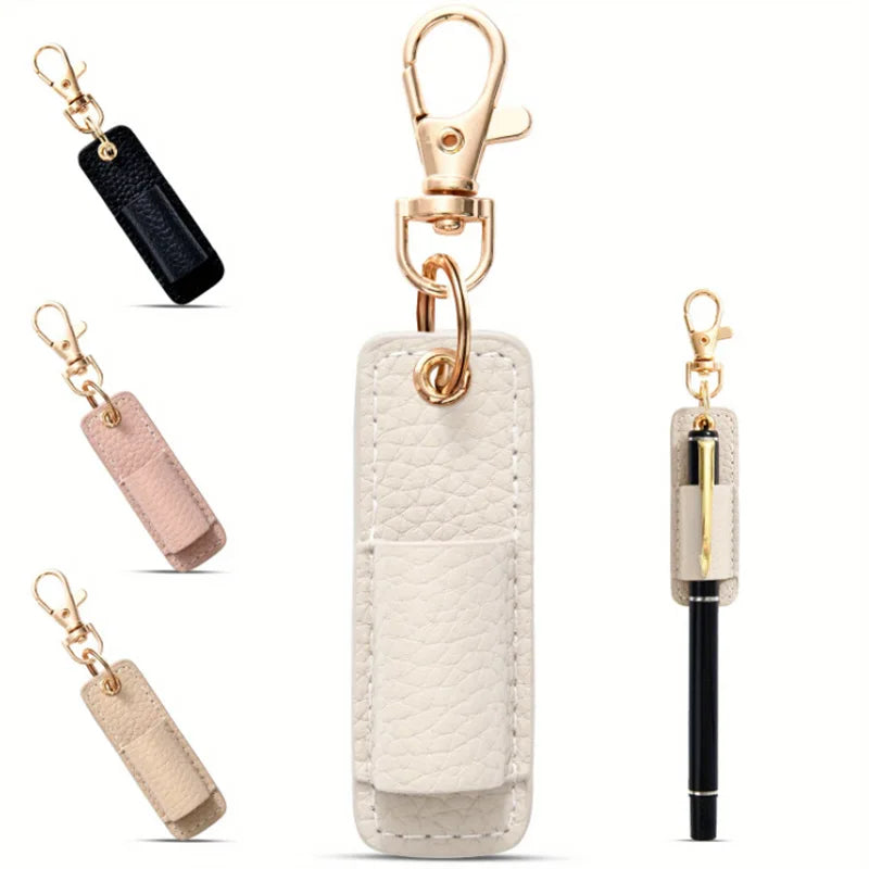 A beige leather pen holder keychain with a gold-tone clasp and a black leather strap.