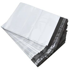 A stack of self-sealing poly mailers in white and black are shown from an angled view.
