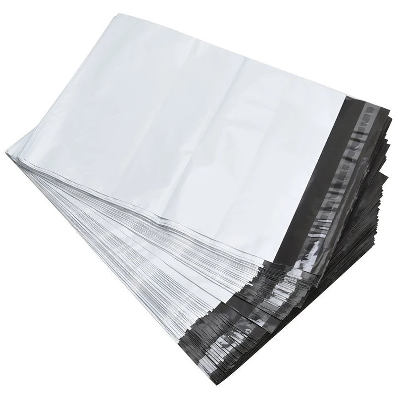 A stack of self-sealing poly mailers in white and black are shown from an angled view.