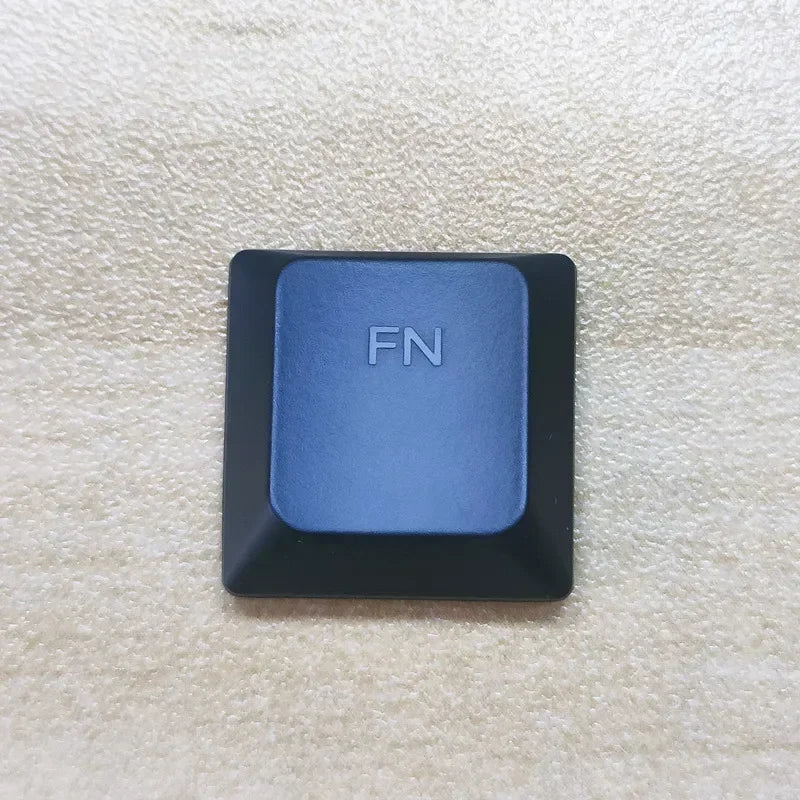 A close-up view of a dark blue function keycap labeled FN on a keyboard.