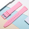 A pink silicone watch strap is shown with replacement tools on a light blue background.