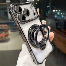 A close-up photo of an iPhone magnetic stand case with a kickstand and lens protection being held by a hand.