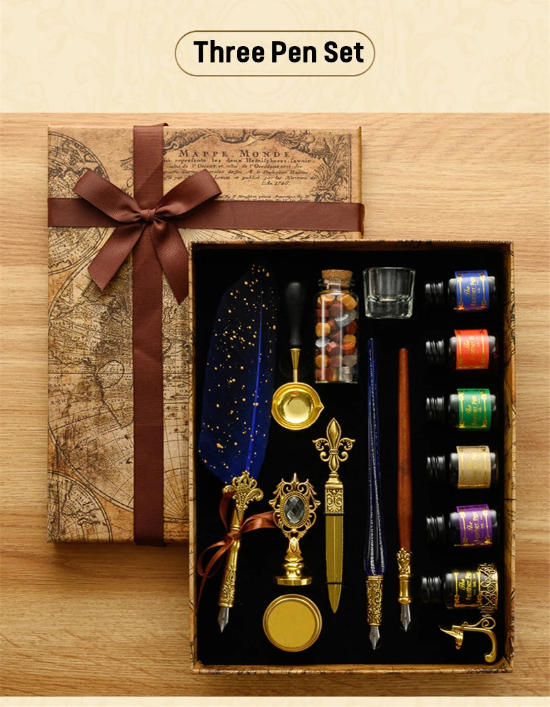 A wooden box containing a three-pen set with gold and silver fountain pens, ink, and wax seals, resting on an antique map.