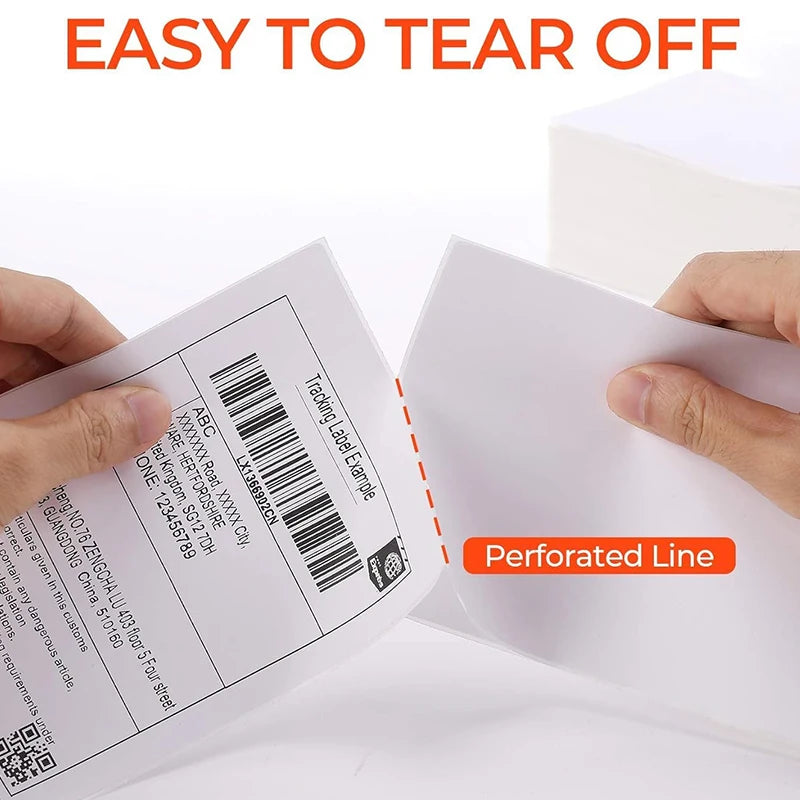 Hand tearing off a perforated thermal shipping label for product packaging.