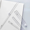 A set of precision folding transparent rulers laid out on a white background.