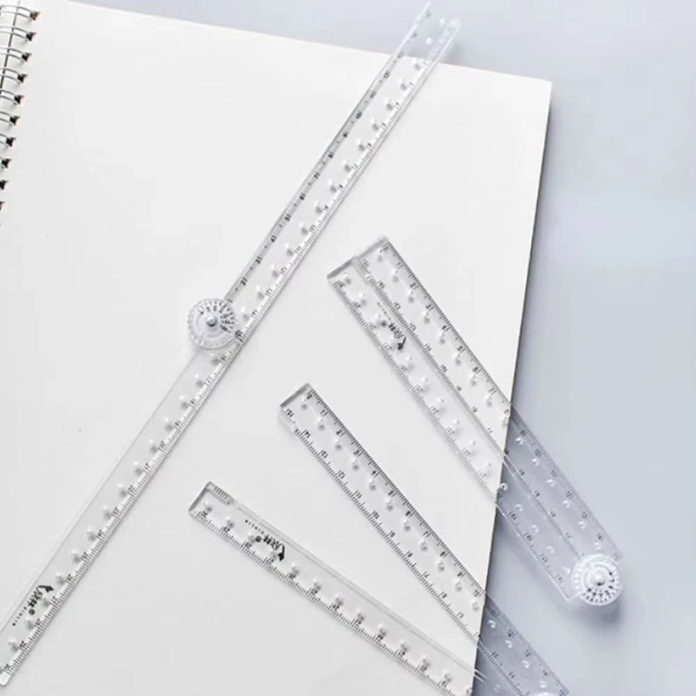 A set of precision folding transparent rulers laid out on a white background.