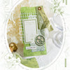 A flat lay of a green and lush paper craft kit featuring vintage style paper, floral elements, and decorative paper goods.