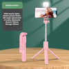 A pink selfie stick tripod with an LED light and a mobile phone holder is displayed on a wooden surface.