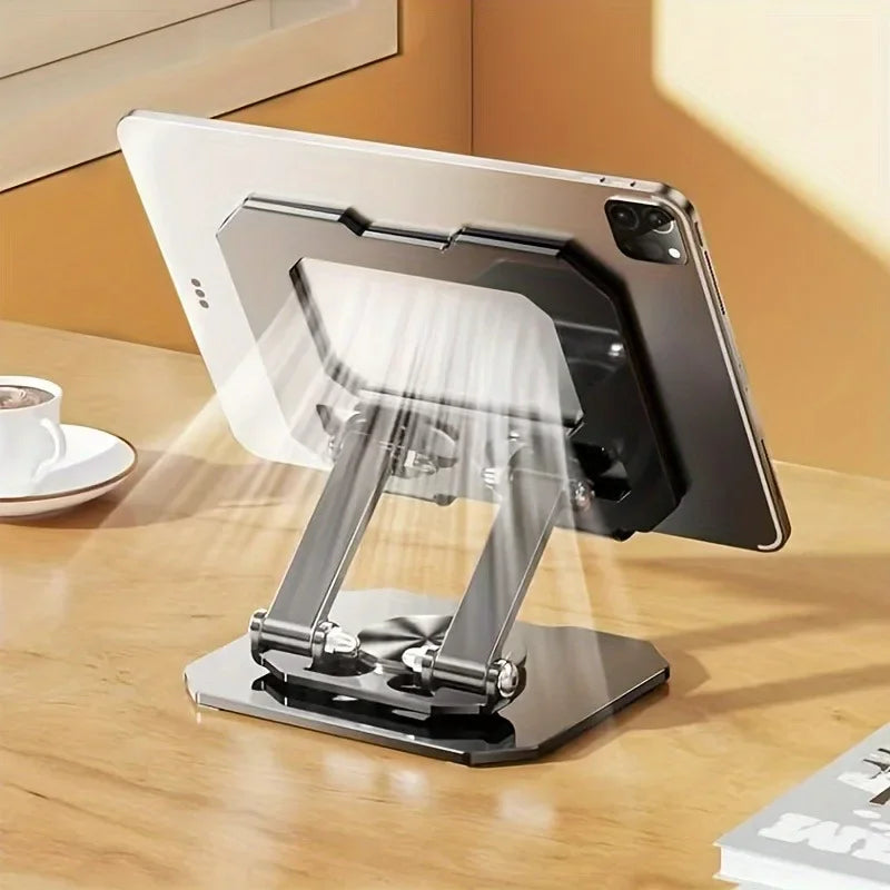 A silver tablet stand is shown with a tablet resting in its adjustable foldable design on a wooden table.