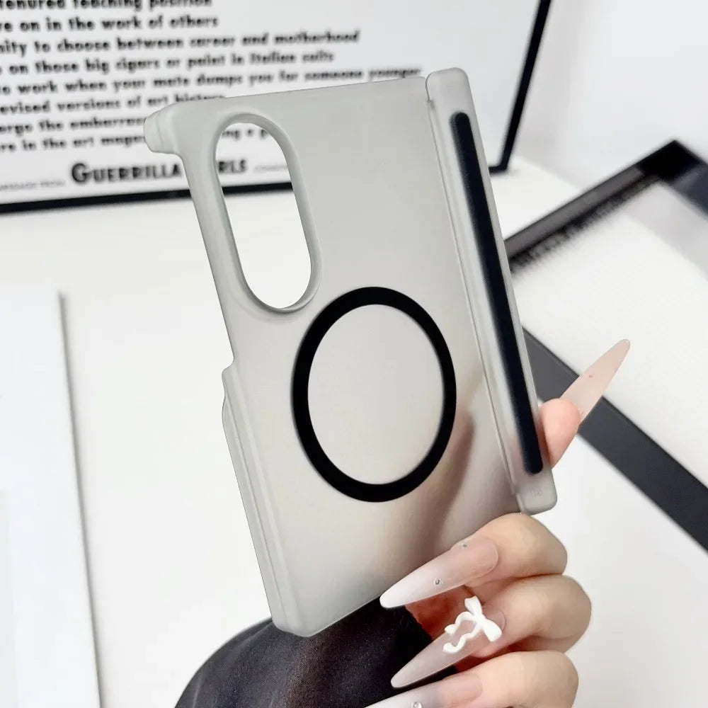 A hand holds a silver Samsung Galaxy Z Fold case with a circular cutout on the back.
