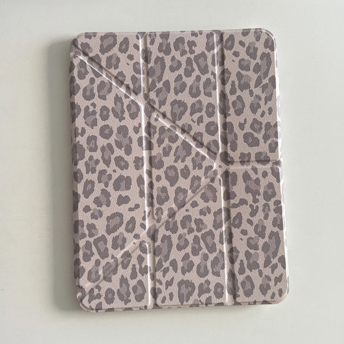 A light gray leopard print leather case designed for an iPad.