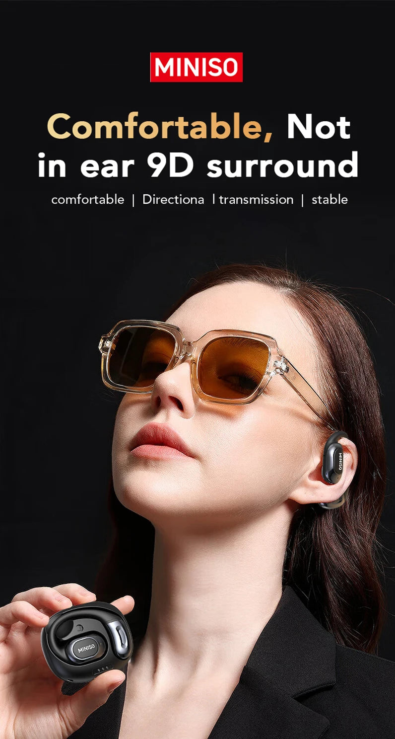 A woman is wearing transparent sunglasses and open-ear wireless earbuds while looking upwards.