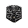 A black enamel lapel pin featuring a stylized open book design with text that reads We lose ourselves in books we find oursel