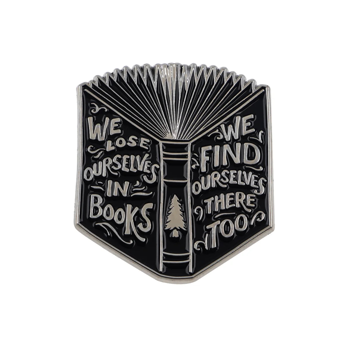 A black enamel lapel pin featuring a stylized open book design with text that reads We lose ourselves in books we find oursel