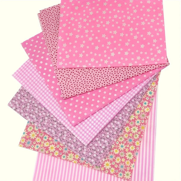 A stack of pink cotton patchwork fabric squares with various patterns including polka dots and stripes.