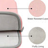 A pink laptop sleeve showing a water resistant layer and fluffy lining details.