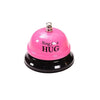Pink metal service bell with the text Ring for a Hug