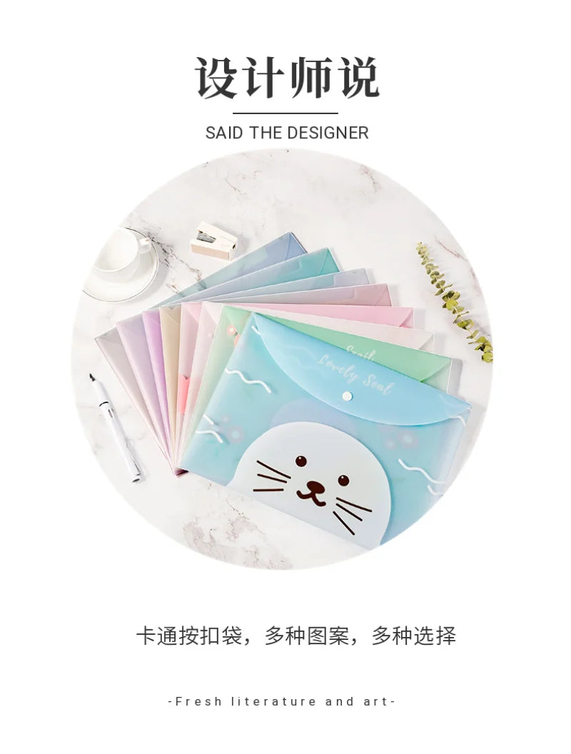 A set of four cute cartoon transparent document pouches for A4 papers in various pastel colors, displayed on a white marble s