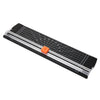 A portable manual paper trimmer with a clear plastic blade and a black body is shown at an angle.