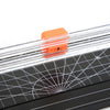 Orange manual paper trimmer with a transparent guide resting on a black cutting mat.