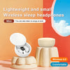 White wireless sleep headphones with a beige stand and earbuds shown in a studio setting.