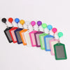 A collection of colorful retractable ID card holders with various colored badge cases arranged in a line.