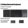 A black folding Bluetooth keyboard with a touchpad shown in various views.