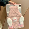 A pink rabbit plush case is being held by a person against a light-colored wall.