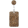 A leopard print retractable badge holder with a round charm attached.