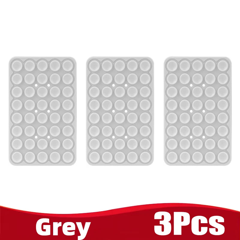 Three grey silicone suction cup phone holders packaged together