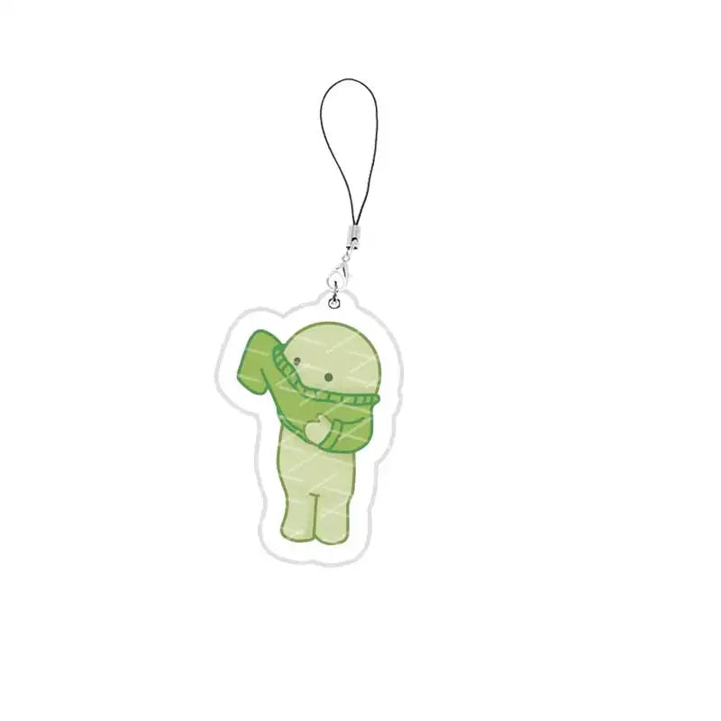A cute green Smiski-inspired character charm attached to a keychain ring.