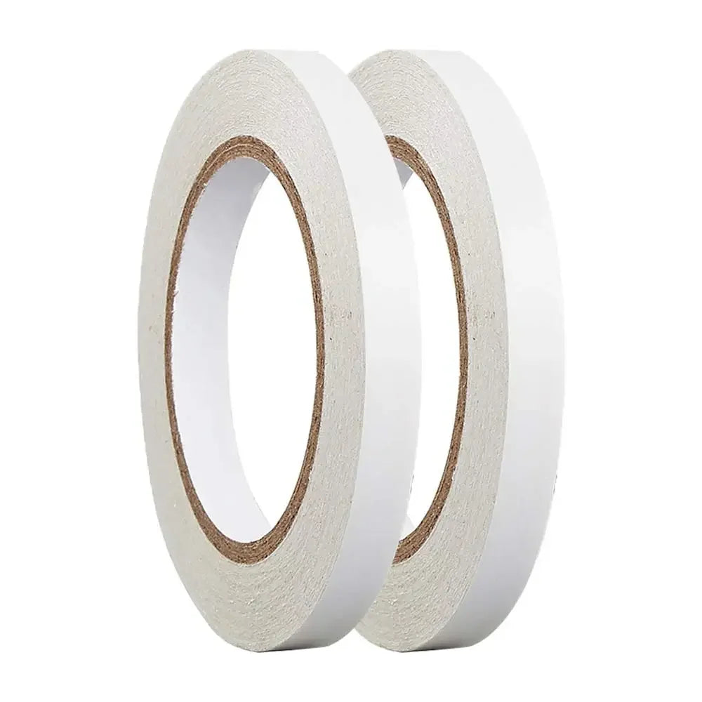 A pair of white double-sided craft adhesive tapes rolled on a dispenser.