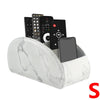 A white marble PU leather remote control holder with five compartments displaying various electronic devices.