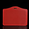 A red PU leather retractable ID card holder with a black clip against a dark background.