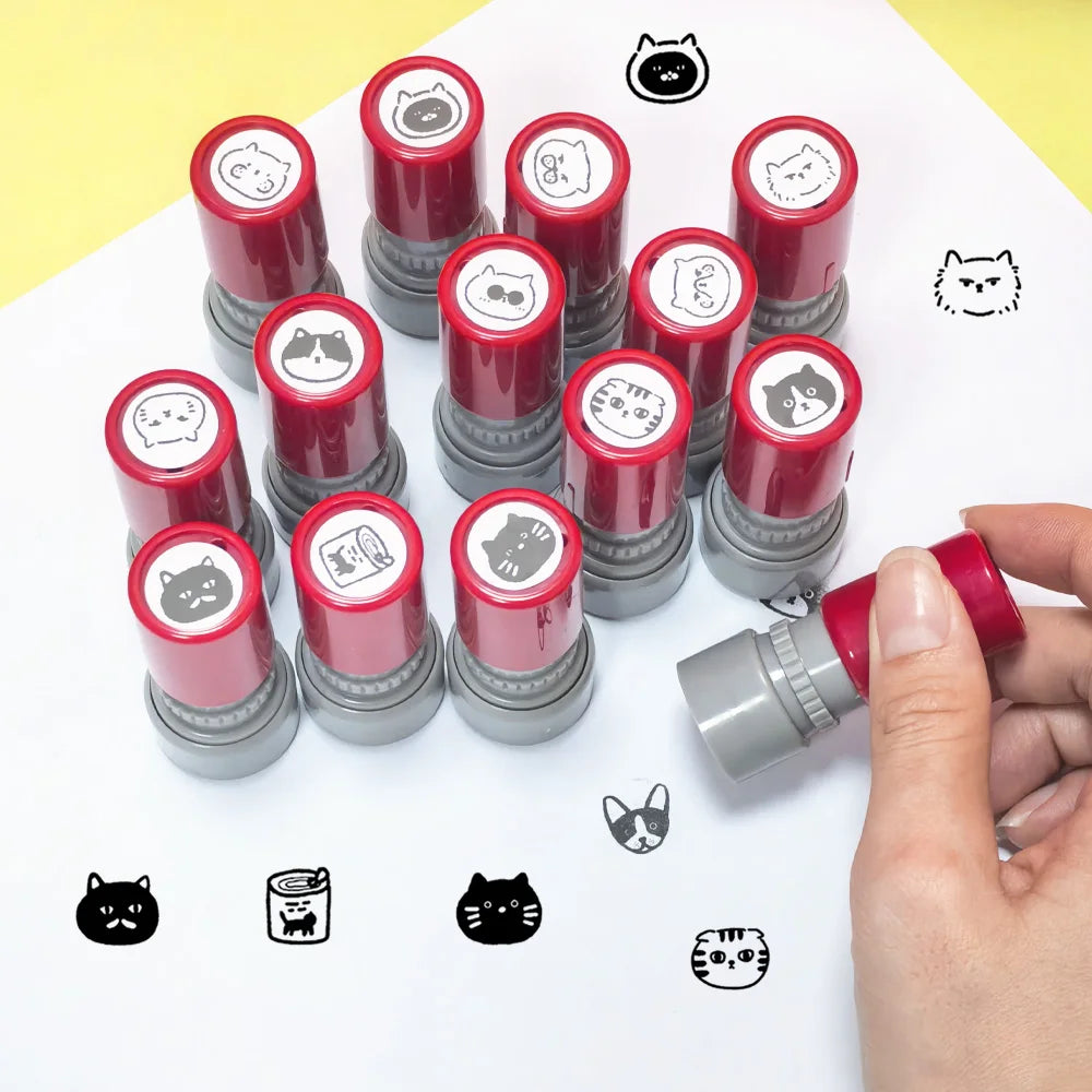 A collection of red and gray teacher stamps featuring various cat patterns used for classroom encouragement.